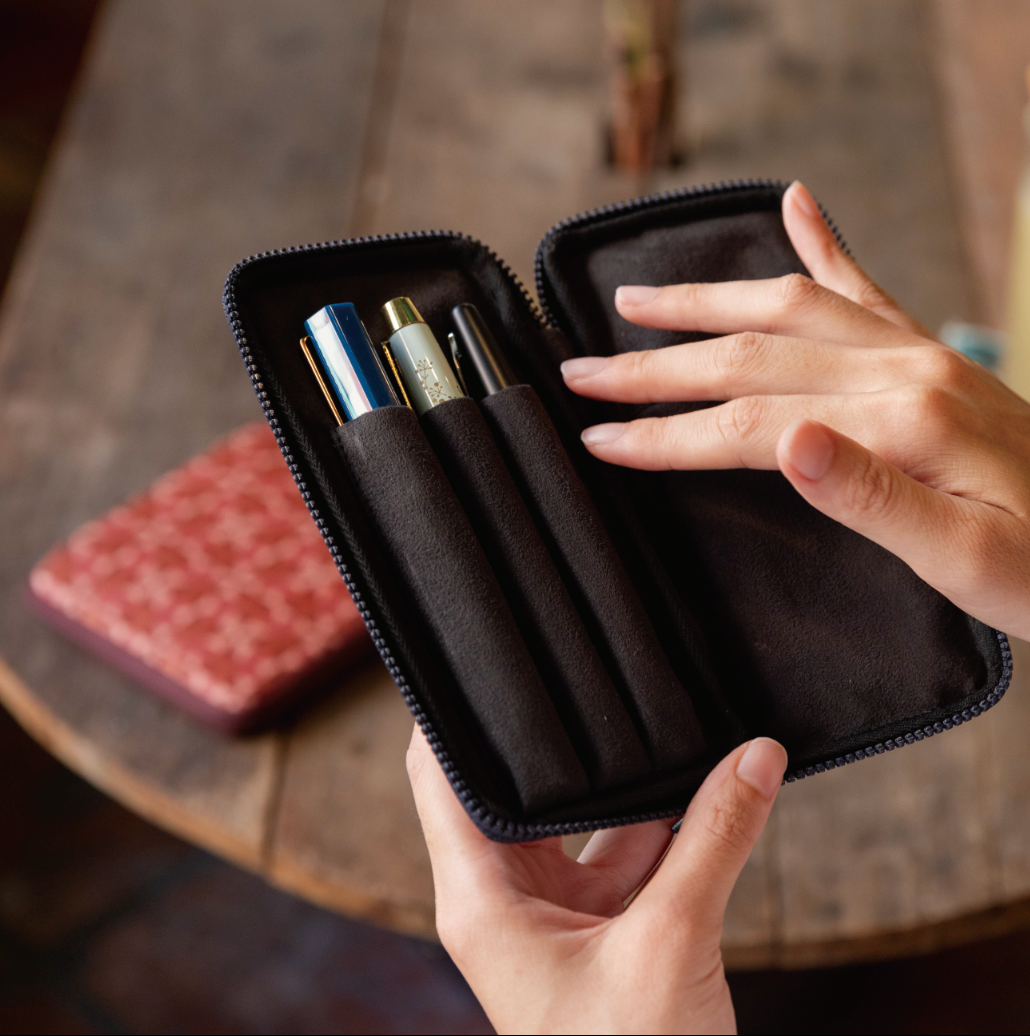 Person showing interior of small pen case