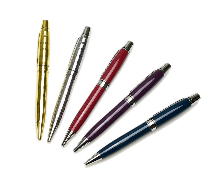 Five ballpoint pens in gold, silver, red, purple, and blue are arranged in a fan pattern on a white background. Each pen has silver accents and a shiny finish.