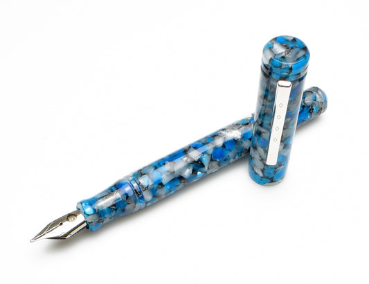The Piper Trading Co. Franklin-Christoph Model 20 Bluestone Fountain Pen NOS is shown with its cap removed and placed beside the pen on a white background, highlighting its blue and white marbled acrylic body, silver recessed nib, and matching clip.