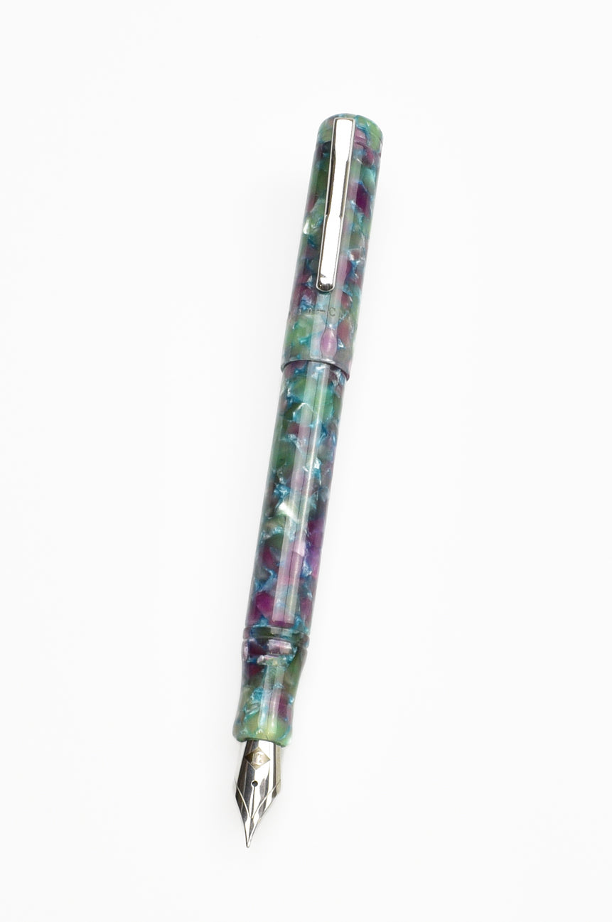 A Piper Trading Co. Franklin-Christoph Model 20 Fountain Pen - Scottish Heather NOS, showcasing a luxurious marbled acrylic in green, purple, and blue shades with a silver clip and nib, is displayed against a white background.