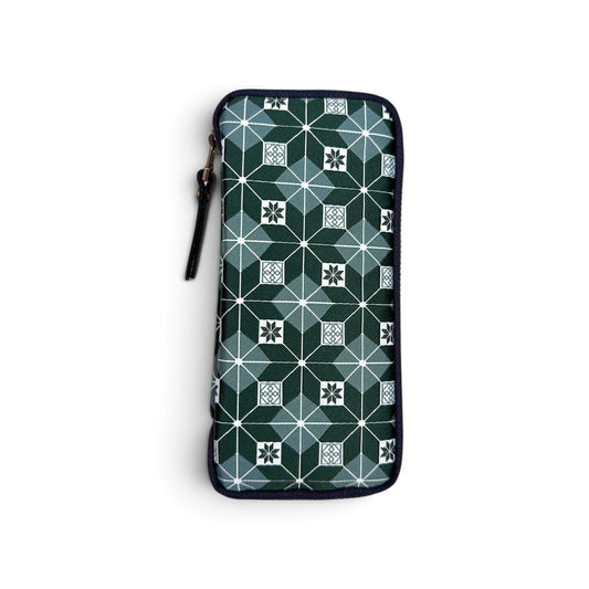 The Kyoku Haku Restitch Emerald 3 Pen Case by Piper Trading Co. is a handmade zippered pouch from Taiwan, inspired by Siraya embroidery. It features a geometric pattern with emerald green, white, and black squares and star shapes, accented by a dark border and a left-side zipper.