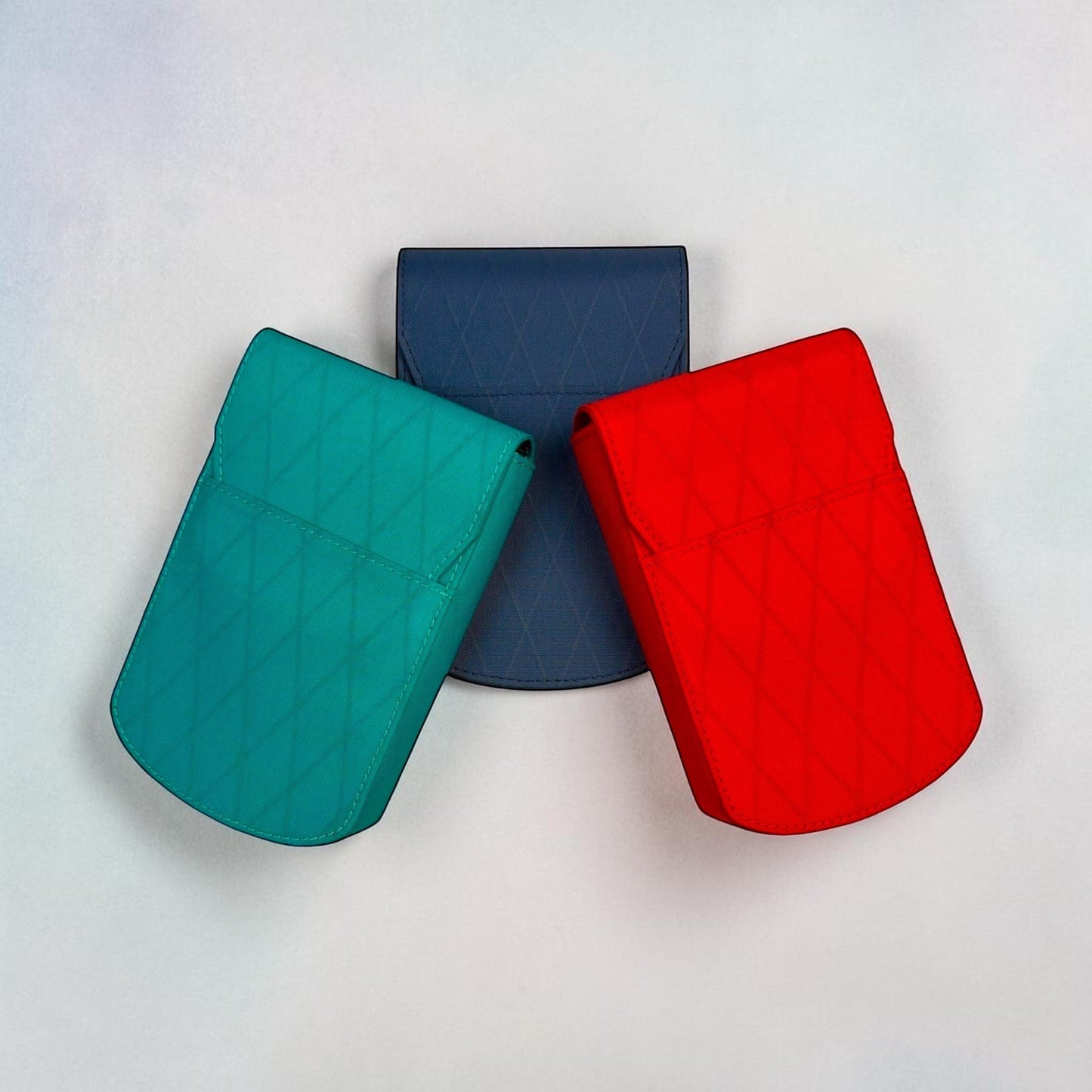 Piper Trading Co. three X-Pac pen cases in teal, navy blue, and red, with diamond stitching detail.